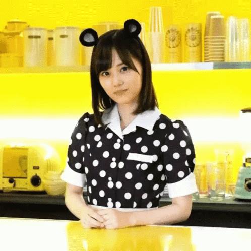 Woman in Black and White Polka Dot Dress with Mouse Ears