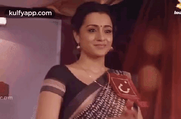 Woman in Black and White Saree Holding Red Sign