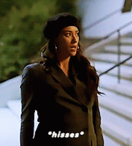 Woman in Black Beret and Jacket Saying Hisses