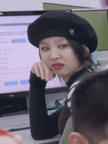 Woman in Black Beret With Letter G in Front of LG Computer