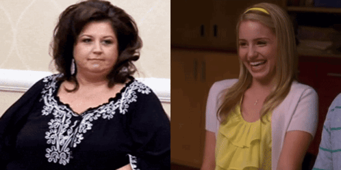 Woman in Black Beside Blonde in Yellow Shirt