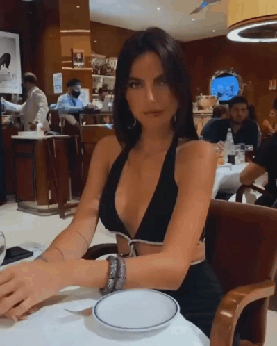 Woman in Black Bikini Top at Table