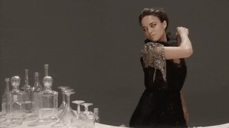 Woman In Black Breaking The Glasses On The Table GIF