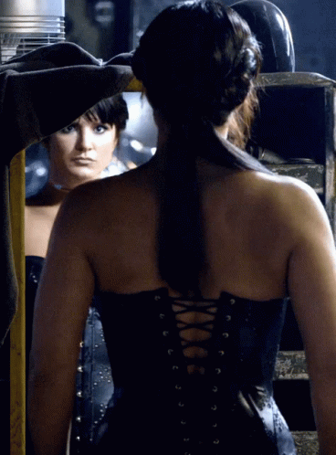 Woman in Black Corset Looking in Mirror