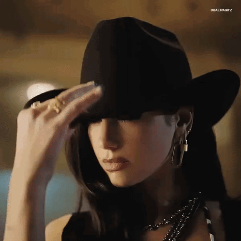 Woman in Black Cowboy Hat Covering Face