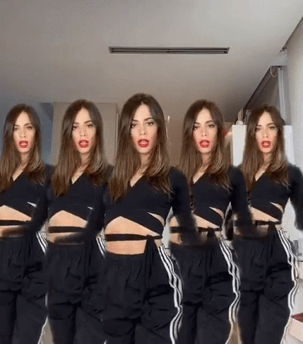 Woman in Black Crop Top and Pants Standing in Row