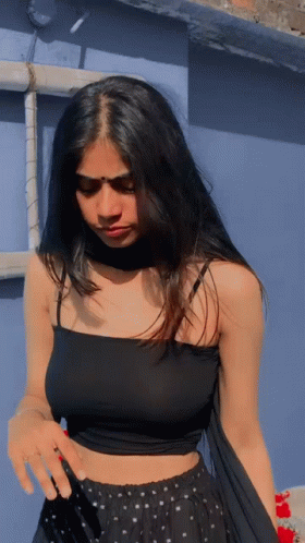 Woman In Black Crop Top And Polka Dot Skirt GIF