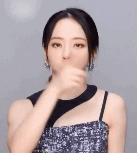 Woman in Black Dress and Earrings Gesturing