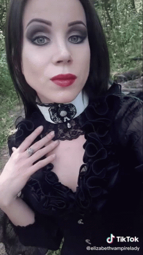 Woman In Black Dress And White Collar TikTok Watermark GIF