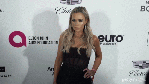 Woman In Black Dress At Elton John AIDS Foundation Logo GIF