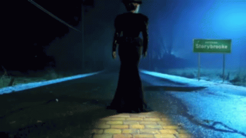 Woman in Black Dress at Starybrooke Sign
