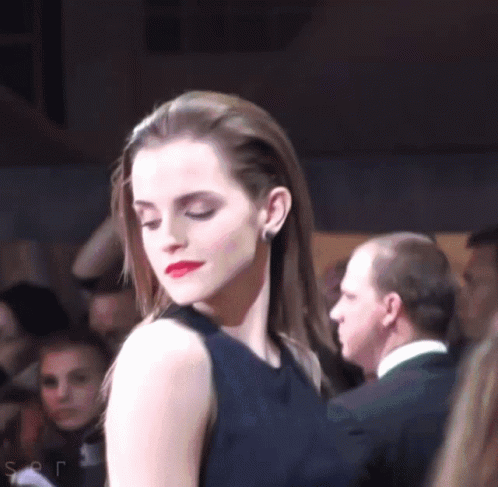 Woman in Black Dress Before Crowd