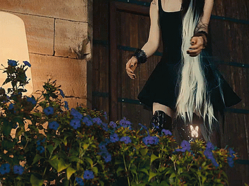 Woman in Black Dress by Wooden Door