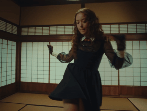 Woman in Black Dress Dancing by Japanese Window