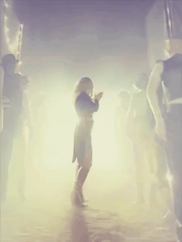 Woman In Black Dress Dancing In Crowd GIF