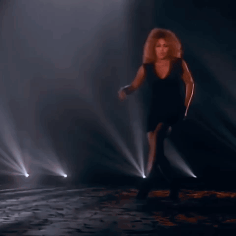 Woman In Black Dress Dancing On Stage GIF