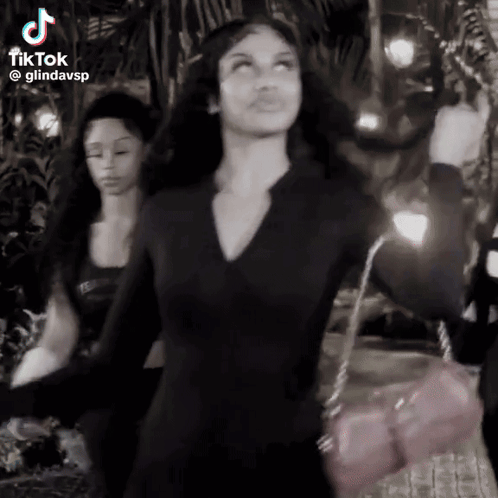 Woman In Black Dress Dancing With Pink Purse GIF