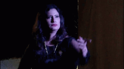 Woman in Black Dress Hand Up in Dark