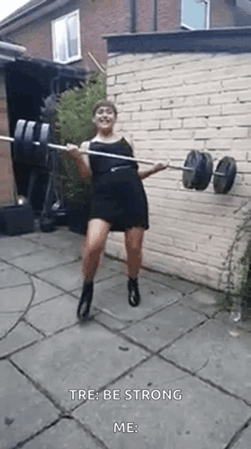 Woman In Black Dress Holding Barbell GIF