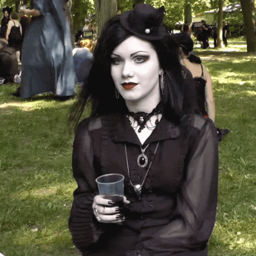 Woman in Black Dress Holding Plastic Cup