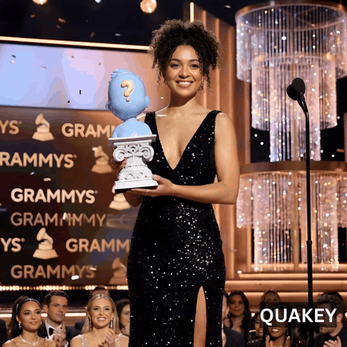 Woman In Black Dress Holding Question Mark Statue GIF