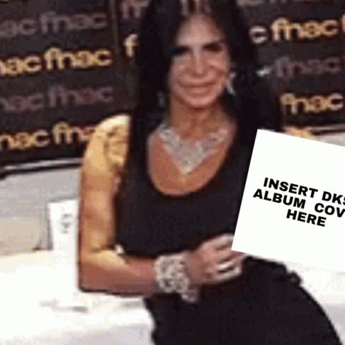 Woman In Black Dress Holding Sign Saying Insert DK Album Cover Here GIF