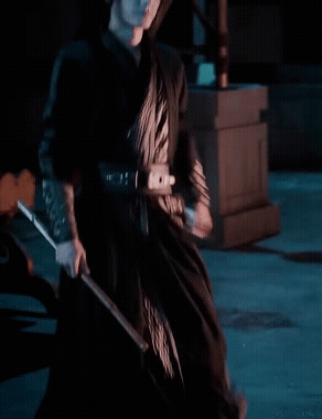 Woman in Black Dress Holding Sword