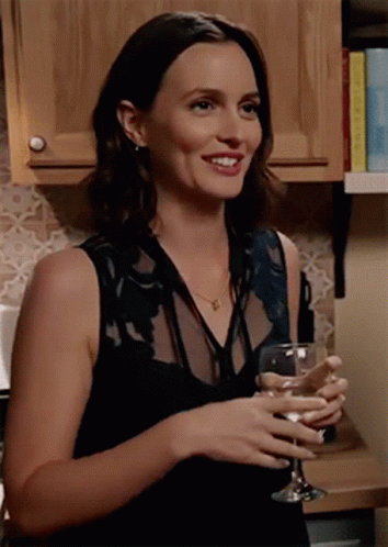 Woman in Black Dress Holding Wine Glass