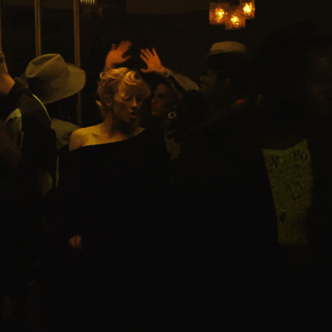 Woman in Black Dress in Dark Room