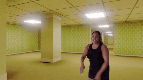 Woman in Black Dress in Empty Yellow Hallway
