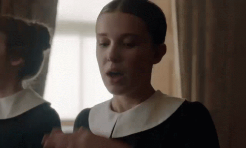 Woman In Black Dress In Front Of Mirror GIF