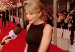 Woman in Black Dress Interviewed on Red Carpet