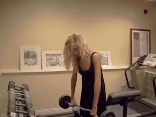 Woman in Black Dress Lifting Barbell
