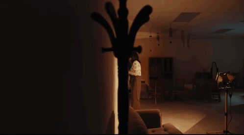 Woman In Black Dress Making Funny Face With Hands Up GIF