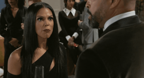 Woman In Black Dress Next To Man In Tuxedo GIF