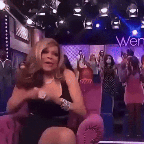 Woman In Black Dress On Pink Chair Saying Wen GIF