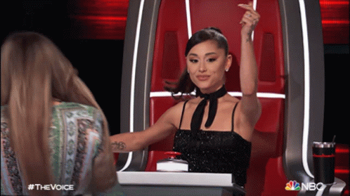 Woman in Black Dress Raising Arm NBC Logo