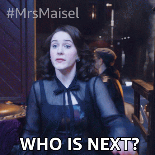Woman In Black Dress Saying Who Is Next GIF