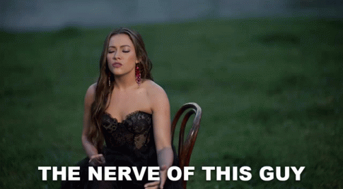 Woman In Black Dress Says The Nerve Of This Guy GIF