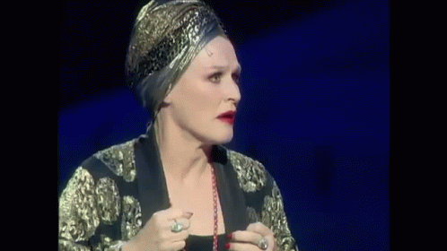 Woman in Black Dress Singing on Stage
