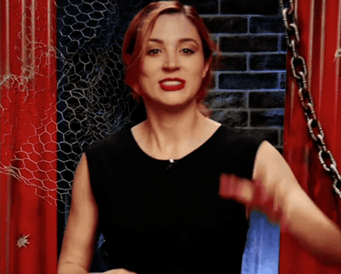Woman in Black Dress Standing Before Red Door