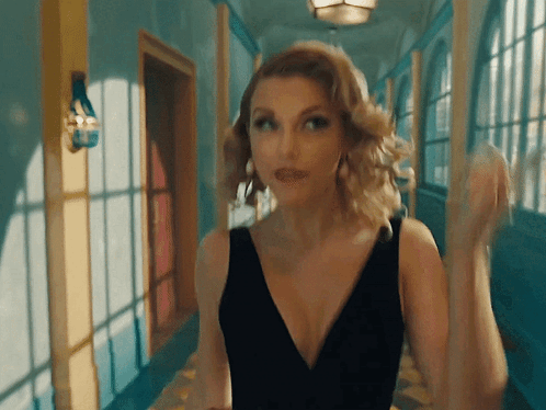 Woman in Black Dress Standing in Hallway