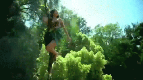 Woman In Black Dress Standing In Woods GIF