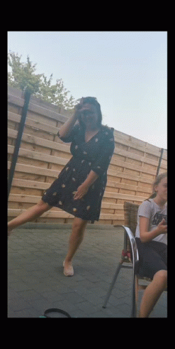 Woman in Black Dress Standing on One Leg