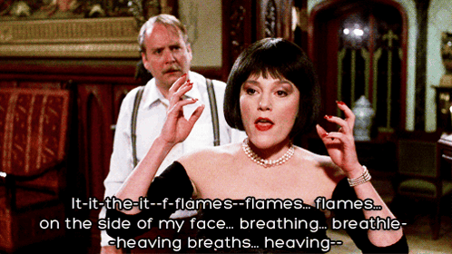 Woman in Black Dress Talking About Flames