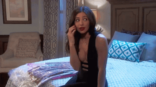 Woman In Black Dress Talking On Phone GIF