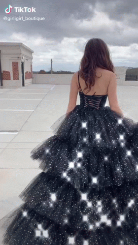 Woman in Black Dress Walking Rooftop