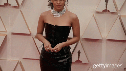 Woman In Black Dress With Oscar Statues GIF