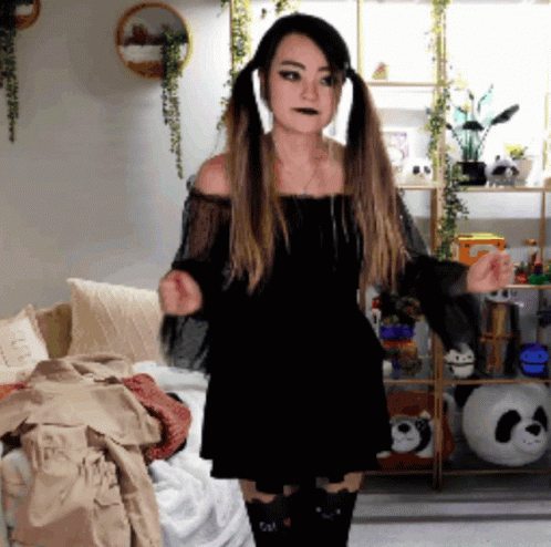 Woman in Black Dress With Pigtails Dancing in Living Room