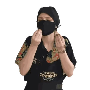 Woman in Black Face Mask and Casa Cerealista Apron